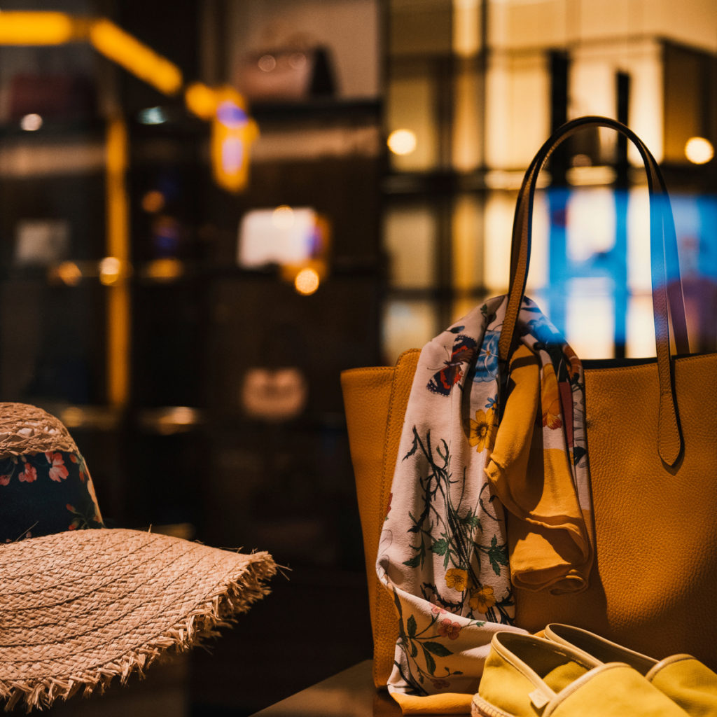 Premium retail store display featuring a yellow tote, floral scarf and straw hat — illustrating strategic transformation in retail and consumer brands.