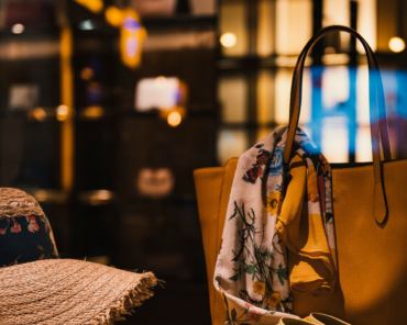 Premium retail store display featuring a yellow tote, floral scarf and straw hat — illustrating strategic transformation in retail and consumer brands.
